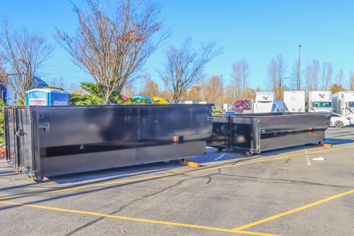 Professional dumpster rental service with roll-off container on residential driveway in Hanson